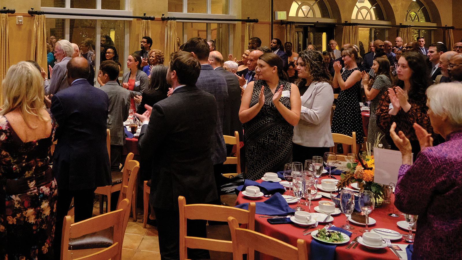 Guests rise to their feet following Judge Kane’s speech.