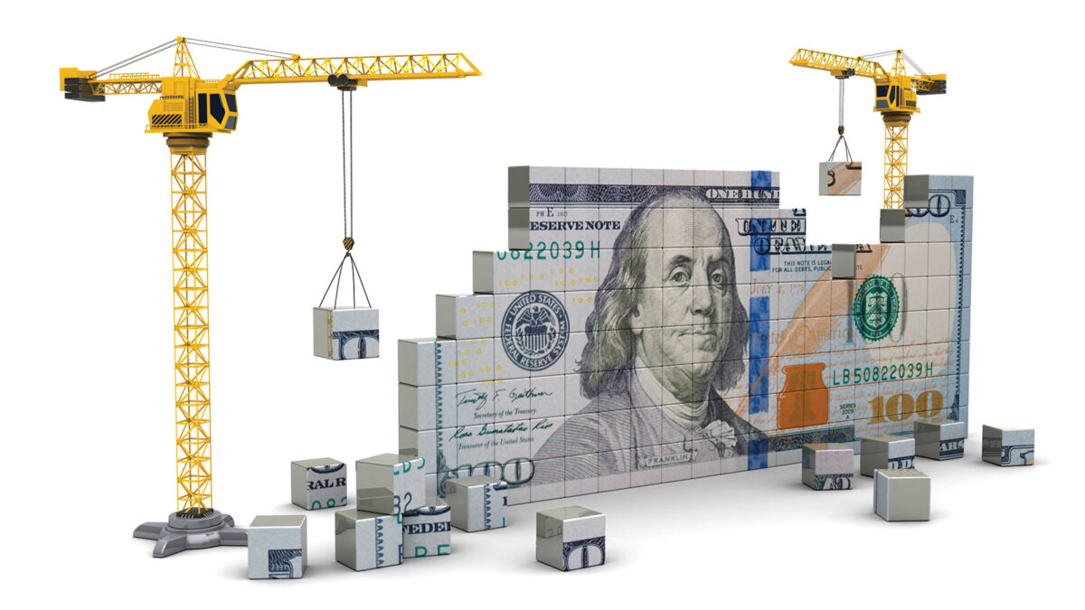 Dollar being put together block by block by two cranes
