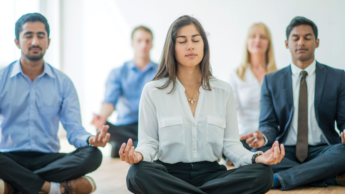 Business people meditating calming