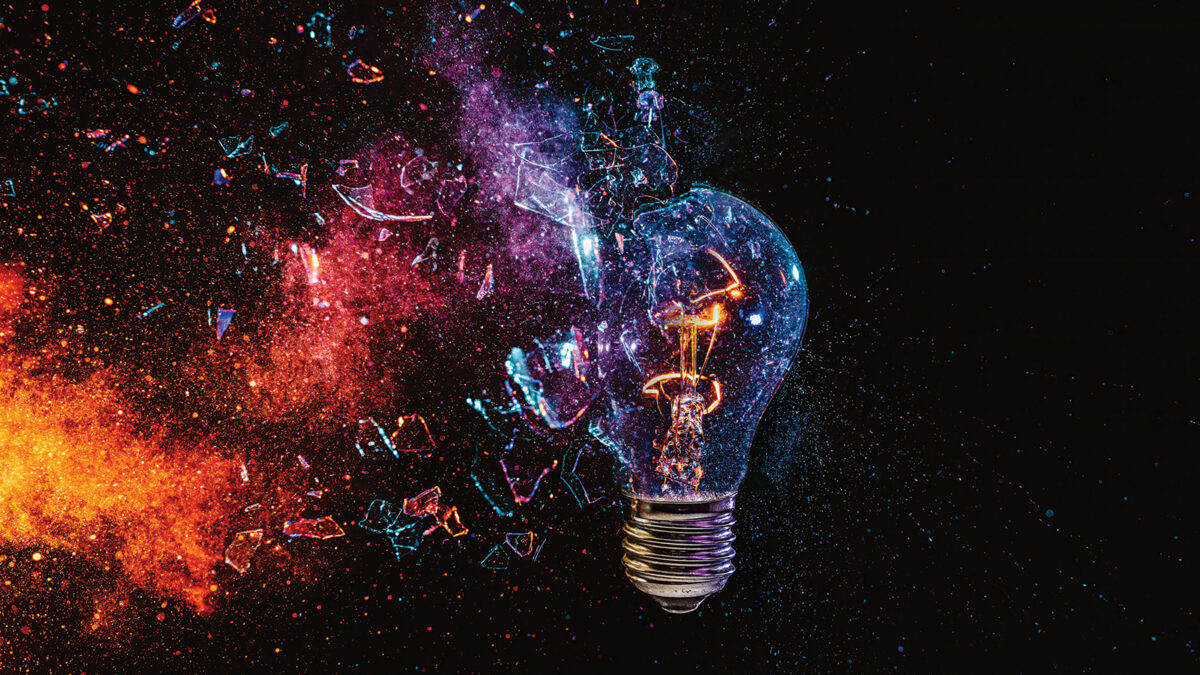 Filament bulb breaking on black background, high-speed photography