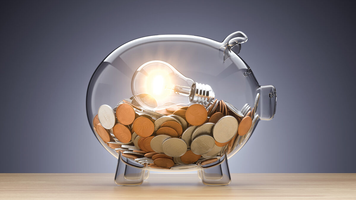 Idea Investment. Clear piggy bank with a light on inside.