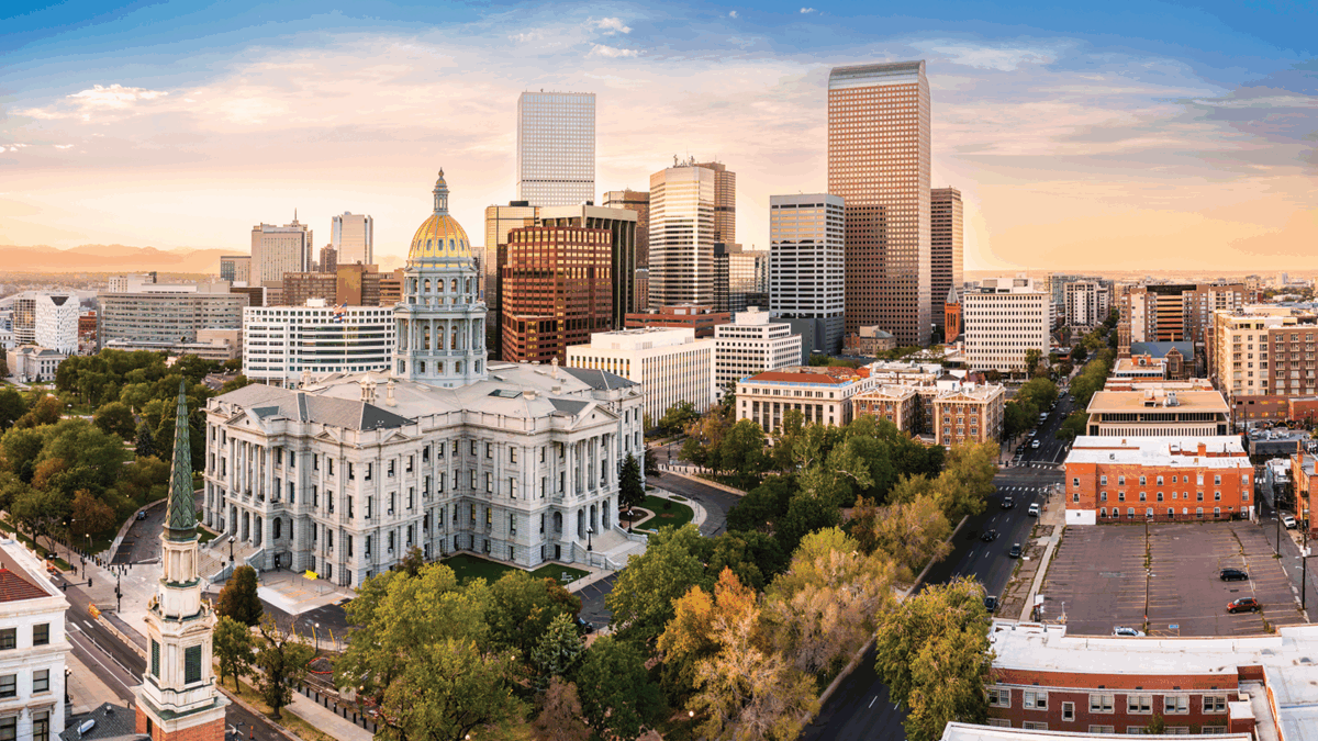 Colorado Capitol and Denver, Colorado skyline at sunset.