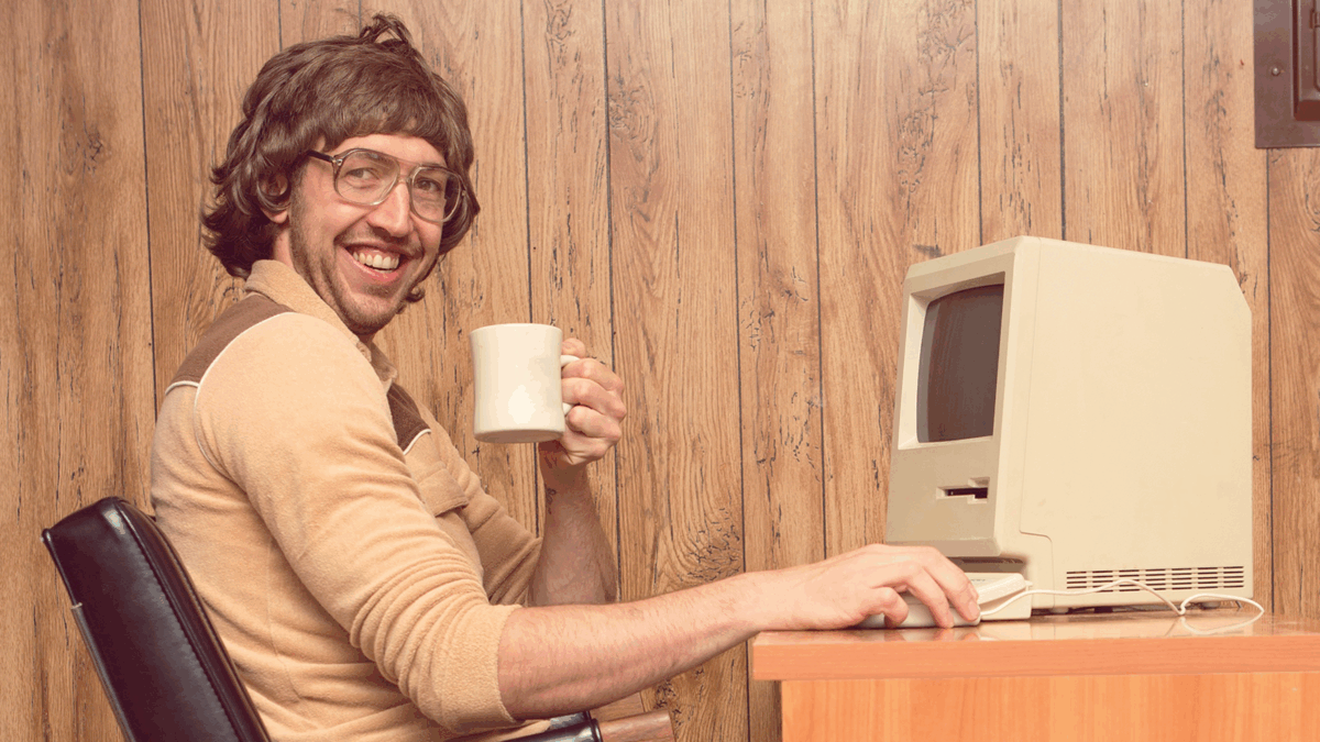 Funny 1980s Computer man at desk with coffee.