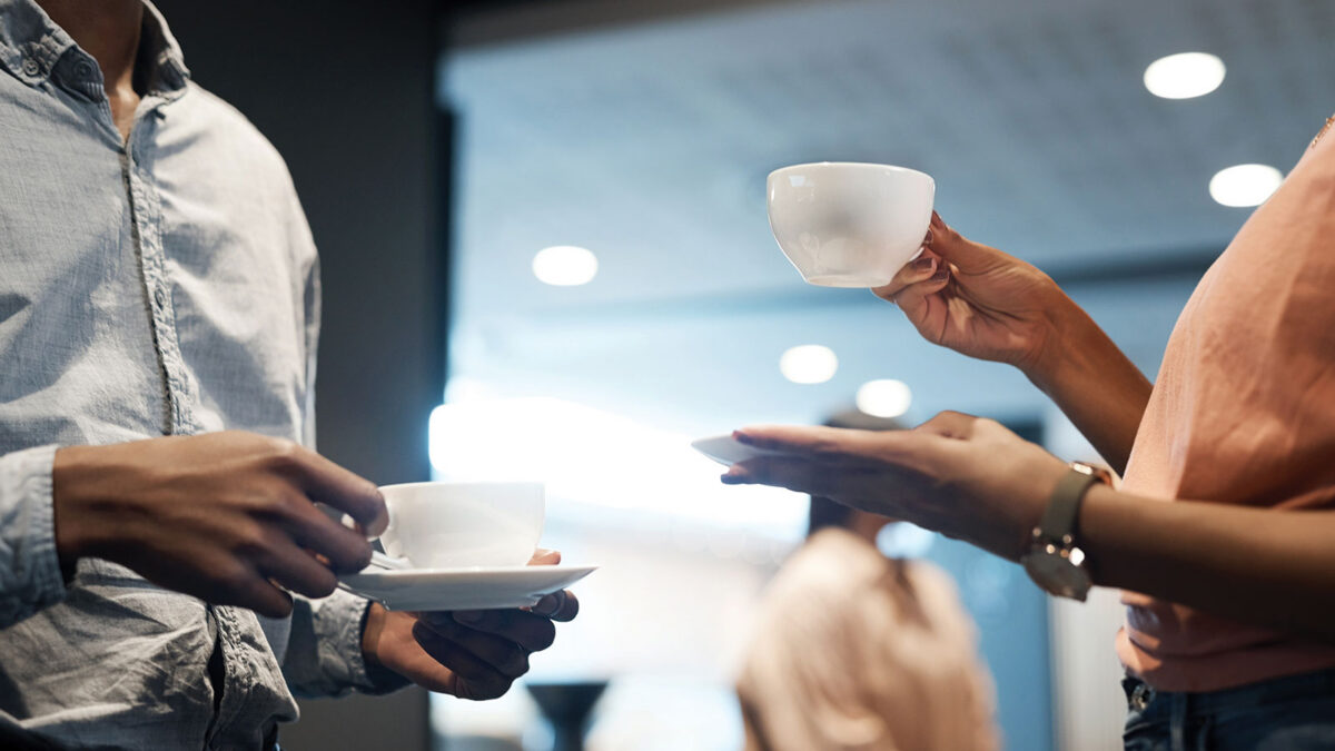 Shot of two unrecognizable businesspeople having coffee at a conference.