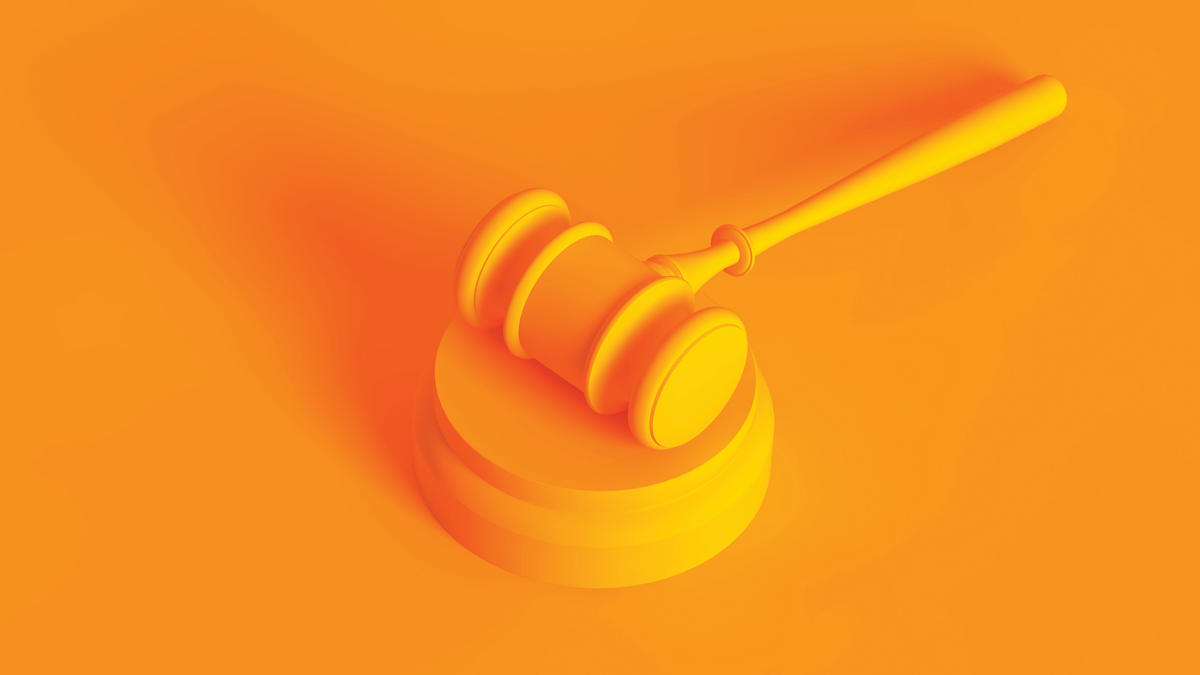 Conceptual image. Law gavel isolated on orange background.