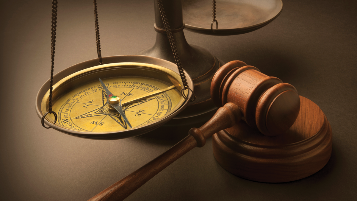 The Courts Direction. Compass, scales of justice and gavel.